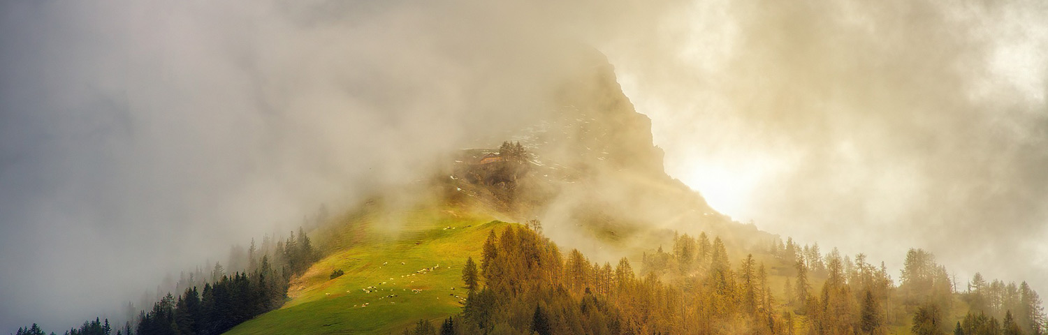 alp mountains with fog at the peak